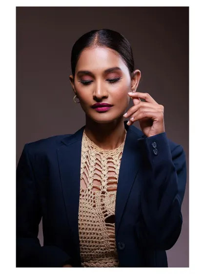 A polished and professional portrait of a model in a blazer. The lighting is clean and the expression is confident.