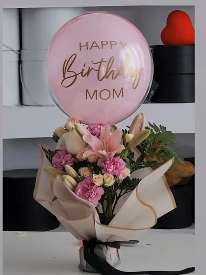 Moms deserve the best. This birthday hamper for a mom includes a beautiful bouquet of lilies and carnations, topped with a personalized pink balloon.