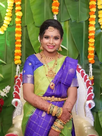 A bright and happy look for a half-saree event. The client's green and blue saree is complemented by classic gold jewellery and fresh, natural-looking makeup.