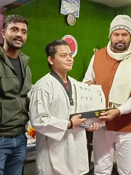 Presenting a certificate and belt to a student who performed exceptionally at the nationals.