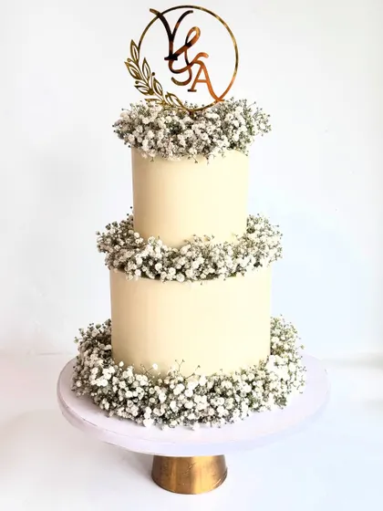 A milestone anniversary cake with wedding cake vibes. This two-tier design with delicate baby's breath is simple, clean, and absolutely gorgeous.