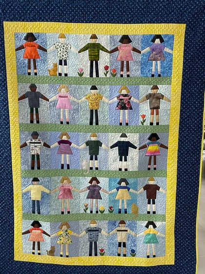 Another view of the "Paper Doll" quilt, a perfect piece of art for a child's room or playroom.