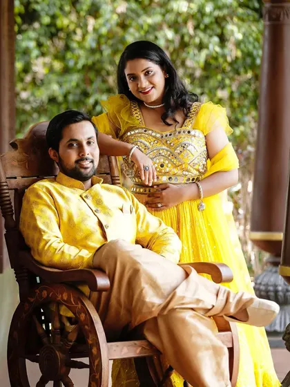 Coordinating in yellow for a Haldi function or pre-wedding event. This couple looks radiant in our matching yellow ethnic outfits, featuring a mirror work anarkali for her and a silk kurta set for him.