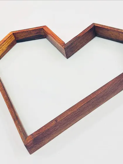 A close-up view of our 10x15 inch heart-shaped teakwood frame. The solid wood construction provides a beautiful, natural border for preserving wedding garlands or creating custom resin decor.