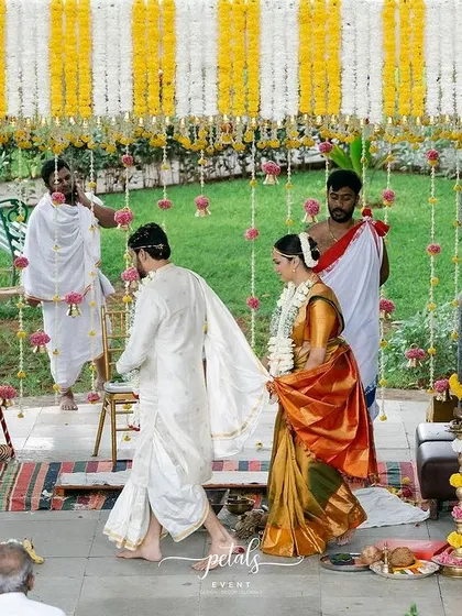 The couple takes their first steps as husband and wife under the traditional floral canopy. This view captures the scale and emotion of the ceremony within the temple-like mandap I designed.