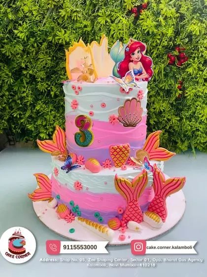 A magical two-tier mermaid cake with characters from The Little Mermaid. The pastel colours and underwater details like shells and tails make it an ocean dream.