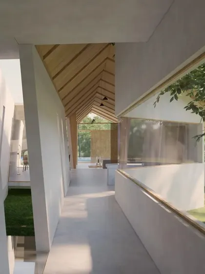 This hallway in the Cumin Residence is designed to feel like a bridge between indoor and outdoor spaces. A long, horizontal window frames the garden, while the pitched ceiling draws the eye forward.