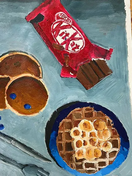 A close-up of a food painting, showing the details on the waffle and the highlights on the chocolate bar wrapper. These are the details that make a painting convincing.