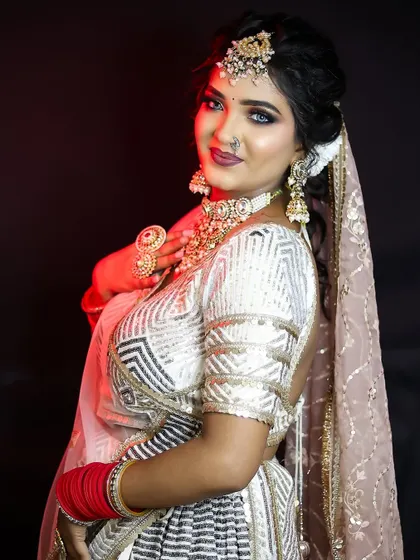 The full look, showing how the silver-toned makeup complements the modern and elegant outfit.