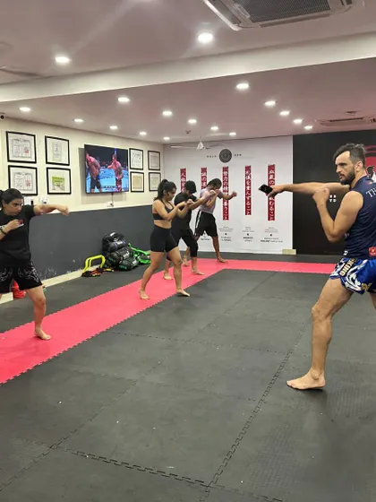 Our classes move together, building a shared rhythm and energy. Students practice their striking stance and punches in unison, learning the foundational movements of boxing and kickboxing.