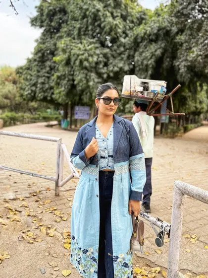 A closer look at this layered Indo-western outfit. The embroidered floral details on the light-wash jacket add a touch of desi craftsmanship to the denim-on-denim look.