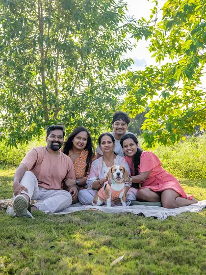 A full family portrait from June the Beagle's outdoor shoot. Getting everyone together, including the furry members, makes for a complete and cherished family photo.