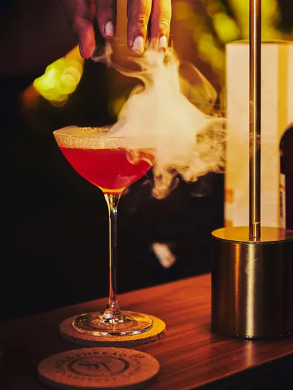 A unique creation for a private party. This martini combines the flavors of blood orange and Himalayan rhododendron, finished with a dramatic swirl of smoke.
