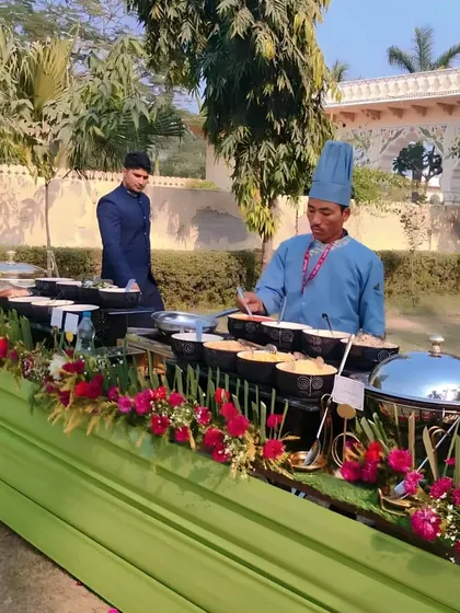 Our chef is busy at a live pasta station during a daytime wedding event. Guests can choose their ingredients and watch as their personalized pasta dish is prepared right in front of them.