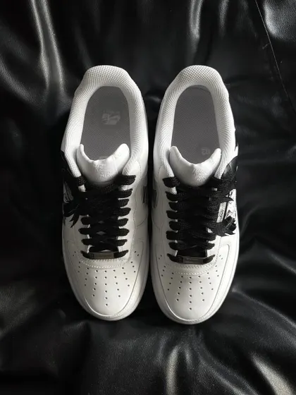 A top-down view of the Itachi custom sneakers, highlighting the clean design and black laces.