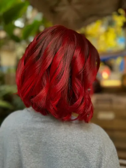 Another angle of the fiery red bob. The color is so rich and vibrant, it's impossible to ignore. This is a bleach color.