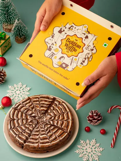 A Christmas-themed shot for The Belgian Waffle Co., featuring their waffle cake. This image is perfect for a brand looking to position its product as a festive gifting option.