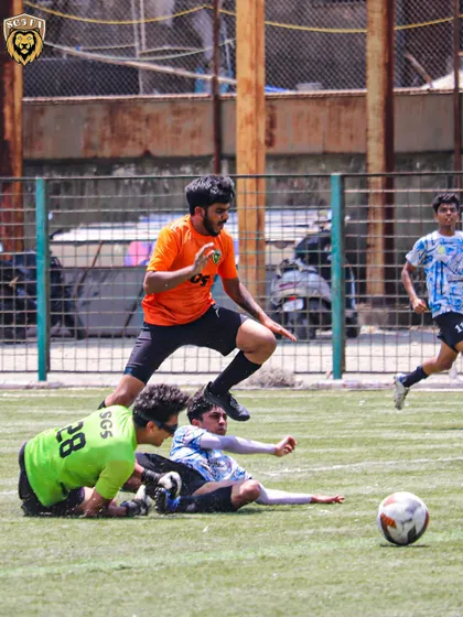 A tough tackle during our MFA First Division match against Springfield FC. Our players are trained to be strong and decisive in challenges.