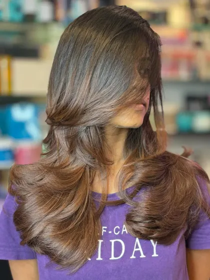 A gorgeous example of a layered cut enhanced with subtle hair color. The lighter pieces add dimension and make the layers pop.