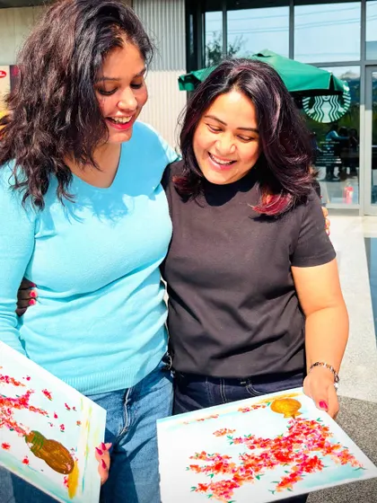 Two friends sharing a laugh and their finished bougainvillea paintings. Our workshops are filled with these happy, candid moments.