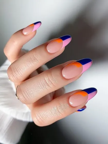 Bold and graphic, this color-blocked French manicure uses sharp blocks of navy blue, hot pink, and vibrant orange. This design is a modern and eye-catching way to wear multiple colors.