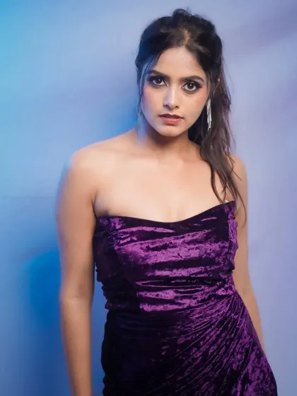 A strong and direct portrait against a cool blue background.