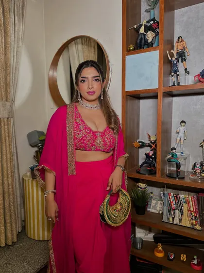 Another view of this stunning pink ensemble. The makeup is the perfect finishing touch, tying the whole look together with a pop of color.