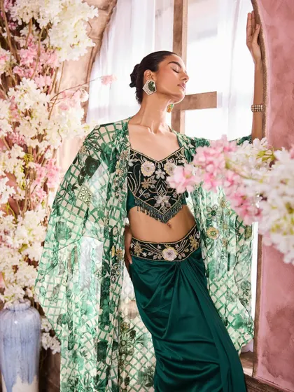 A dramatic pose showcasing an embroidered green and black outfit. I created a look with defined eyes and contoured cheeks to match the high-fashion styling.