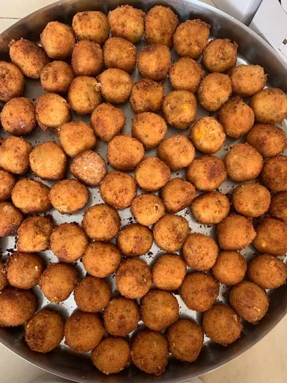 Another tray of golden-brown Corn & Cheese Balls.