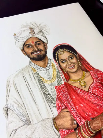A close-up of the wedding portrait from Gujarat, showing the texture of the bride's red dress and the groom's turban.