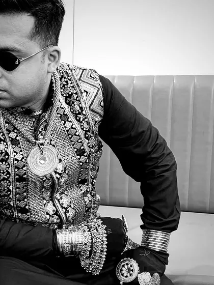 A black and white shot that highlights the details of my accessories. The layered necklaces, bracelets, and rings are a key part of my stage persona.