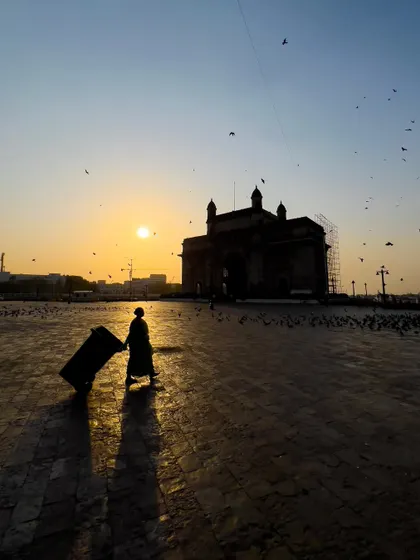 A lone traveler silhouetted against the setting sun at the Gateway of India in Mumbai. I aimed to capture a different, more personal perspective of this iconic landmark, focusing on the journey rather than the destination.