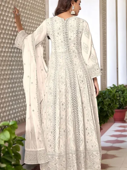 An ethereal white Anarkali suit that's perfect for any special occasion. The heavy thread, zari, and sequence work give it a divine glow.