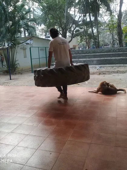 Another shot of the tire carry, showing the physical effort involved in our conditioning sessions.