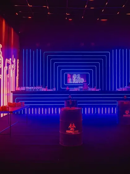 The bar area was designed with a backdrop of concentric blue neon squares, creating a hypnotic effect. We used oil drums as high tables to enhance the industrial, underground theme.