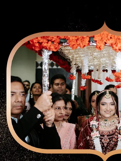 The bride's entry under a traditional 'phoolon ki chaadar', a timeless and emotional moment.