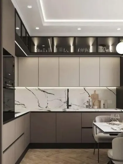 An open kitchen and dining concept. The kitchen features two-tone cabinets and a marble backsplash, while seamlessly connecting to the dining area.