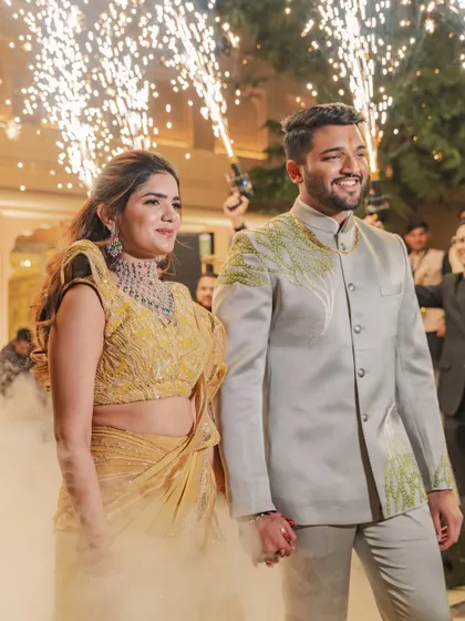 Mehak and Shiven make their grand entrance with sparklers and smoke. This photo perfectly captures the excitement and glamour of their Sangeet night in Jaipur.