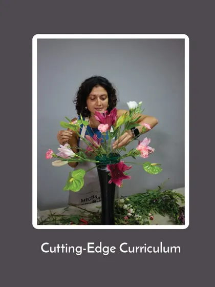 My curriculum is cutting-edge, blending timeless principles with modern trends. This student is working on a contemporary piece, reflecting what's current in the floral design world.