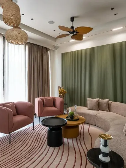 A cozy living room in Paschim Vihar where I used a palette of olive green and dusty pink. The curved sofa and fluted wall paneling add softness and texture, creating a warm and inviting atmosphere.