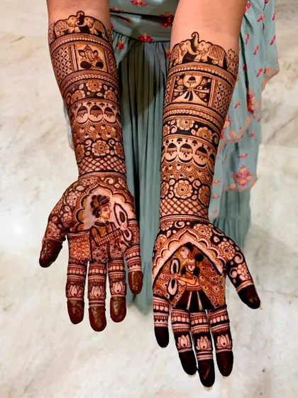 An angled view showing the flow of the design from the palms to the arms. You can see how the different bands of patterns work together to create a cohesive look.