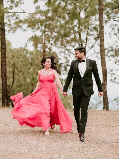 Capturing movement and laughter, this photo shows the couple running hand-in-hand through the woods. It’s a perfect example of a fun and candid moment during a destination pre-wedding shoot.
