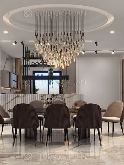 The dining space in the Janakpuri project, anchored by a magnificent crystal chandelier and a custom bar area, perfect for hosting guests.