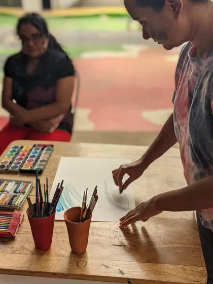 A participant sketching during a self-reflective art session. These moments of quiet introspection are just as important as the playful ones.