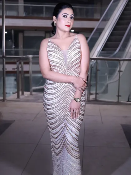 A full-length shot of the rose gold sequin gown, emphasizing its sleek, bodycon silhouette.
