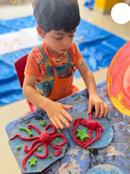Creating sea creatures with clay during our "Art & Artists" camp. This activity helps children develop their fine motor skills and learn to transform a simple block of clay into a character from their imagination.