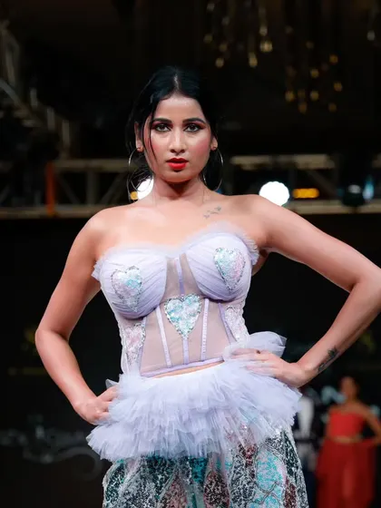 A confident pose from a model wearing a pastel corset gown, one of the show's standout pieces.