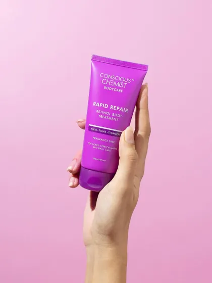 Clean, simple, and direct. A hand holds the product against a solid pink background, keeping all the attention on the vibrant packaging and the brand name.