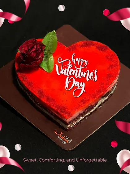 A stunning red heart-shaped cake with a glossy finish, perfect for a memorable Valentine's Day celebration. It's sweet, comforting, and unforgettable.