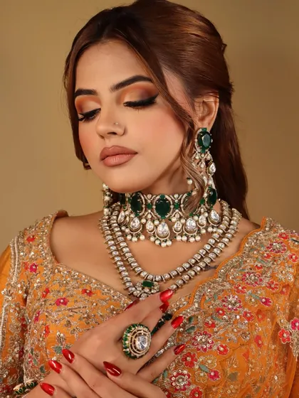 An eyes-closed shot to show the beautiful half-cut crease and the blend of marigold and amber hues on the eyelids.
